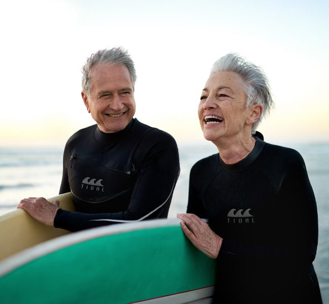 Elderly couple surfing